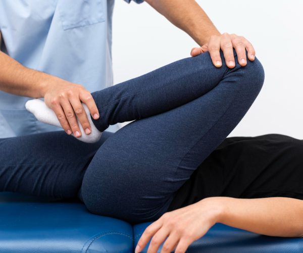 physiotherapist-doing-exercises-with-female-patient
